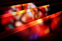 Morning sun projecting color onto pews from Altar Stained Glass Window.