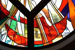 Detail: west stained glass window, "Reach Out". Made from imported mouthblown glass.