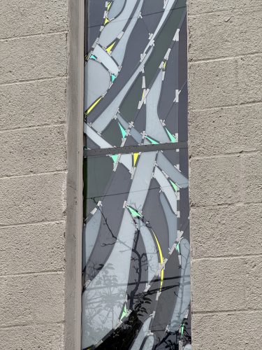 Exterior detail revealing the reflectivity of white Opal and Opak glasses, and mirror-like relfections from dichroic glass.