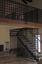 Temporary photo of "Oasis Cross" and wrought iron stairwell during renovation/construction.