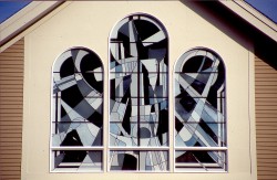 "Trinity Triptych" above Main Entrance: Exterior view of reflective German opal glass.