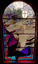 "The Crucifixion" stained glass window with crumbling temple and rent walls.