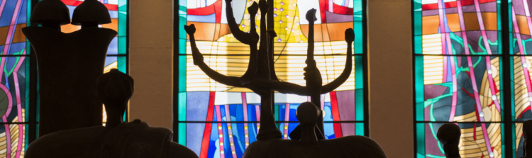 Five Books of Moses Windows seen through Elbert Weinberg's larger-than-life-size bronze sculpture, 