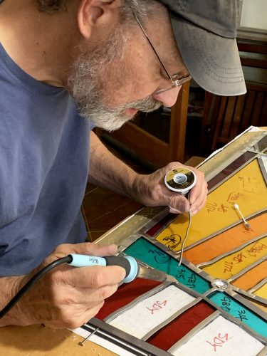 When precise and consistent, soldering becomes a beautiful, textural aspect of stained glass. As will be seen shortly, the contrast between lead and solder is emphasized after caulking/cleaning oxidizes lead to a dull gray and polishes solder to a silvery, satin finish.   